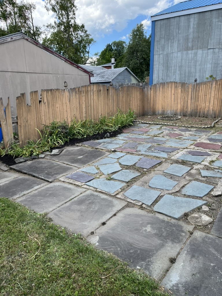Cleared stone patio and freshly defined planting bed